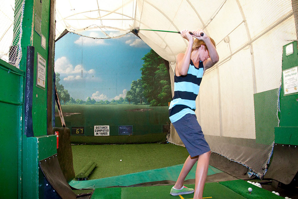 Guest Takes A Swing In The Driving Range