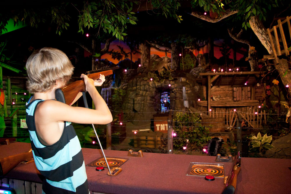 Guest Takes Aim On Shooting Gallery